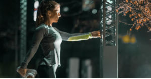 Woman stretching outdoors at night with calm focus, representing preparedness psychology, emotional composure, and confidence under pressure. preparedness psychology
